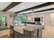 Bright living room featuring wooden beams, and an island with granite counters and a farmhouse sink at 10304 Stallion Way, Bahama, NC 27503