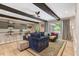 Open-concept living area with exposed beams, bar seating, and sliding door access to the deck at 10304 Stallion Way, Bahama, NC 27503