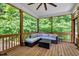 Cozy screened porch with comfortable seating and wooded views offers a relaxing outdoor space at 10304 Stallion Way, Bahama, NC 27503