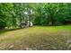 View of a spacious backyard with lush greenery and trees at 1033 Cabin Hill Way, Garner, NC 27529