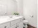 Clean powder room featuring a white vanity, framed mirror, and tiled flooring at 1033 Cabin Hill Way, Garner, NC 27529