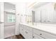A bathroom features a white vanity, modern fixtures, and a mirror reflecting a view of another room at 1033 Cabin Hill Way, Garner, NC 27529