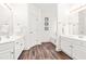 A spacious bathroom showcasing double vanities, modern fixtures, and a connecting doorway at 1033 Cabin Hill Way, Garner, NC 27529