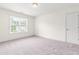 Bright bedroom features a large window and neutral carpeting at 1033 Cabin Hill Way, Garner, NC 27529