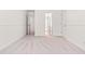 A vacant bedroom has light walls and light carpet, with doorways leading to other rooms at 1033 Cabin Hill Way, Garner, NC 27529