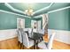 Dining room with wainscoting and hardwood floors leads to other parts of the home at 1033 Cabin Hill Way, Garner, NC 27529