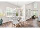 Dining area with a modern round table and chairs, alongside large windows providing natural light at 1033 Cabin Hill Way, Garner, NC 27529