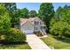 Inviting two-story home boasts a well-manicured lawn, two-car garage and lush trees at 1033 Cabin Hill Way, Garner, NC 27529