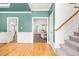 Foyer featuring hardwood floors and a staircase leads to a living room and doorway at 1033 Cabin Hill Way, Garner, NC 27529
