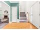 Foyer with hardwood floors and staircase leads to a living room with a fireplace at 1033 Cabin Hill Way, Garner, NC 27529