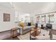 Living room with neutral decor, hardwood flooring, and abundant natural light from the large windows at 1033 Cabin Hill Way, Garner, NC 27529