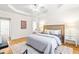 Spacious main bedroom with a tray ceiling, hardwood floors, and large windows at 1033 Cabin Hill Way, Garner, NC 27529