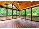 Screened-in porch with wood floors and ceiling provides a great view of the trees at 1033 Cabin Hill Way, Garner, NC 27529