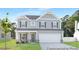 Two-story home with gray siding, dark shutters, and a well-manicured lawn at 105 Mable Court # 10, Lillington, NC 27546