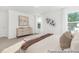 Well-lit main bedroom featuring stylish decor, a large bed, and windows at 105 Mable Court # 10, Lillington, NC 27546