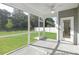 The screened porch includes a ceiling fan, and a view of the backyard and wooded area at 105 Mable Court # 10, Lillington, NC 27546