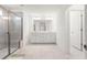 Bright bathroom featuring a large shower and double sink vanity with large mirror at 110 Hickory Grove Dr, Sanford, NC 27330