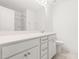 Bright bathroom featuring double sink vanity with a large mirror and a shower/tub combo at 110 Hickory Grove Dr, Sanford, NC 27330