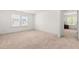 Bright bedroom features neutral carpet, a large window and an open doorway to the hallway at 110 Hickory Grove Dr, Sanford, NC 27330