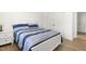 Cozy bedroom featuring a stylish bed with striped bedding and matching white nightstand at 110 Hickory Grove Dr, Sanford, NC 27330