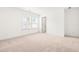 Bright bedroom featuring neutral carpet, white walls and a large window with blinds at 110 Hickory Grove Dr, Sanford, NC 27330