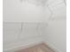 Empty walk-in closet with metal shelving and neutral colored carpet at 110 Hickory Grove Dr, Sanford, NC 27330