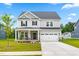 Charming two-story home with a well-manicured lawn and a two-car garage offers great curb appeal at 110 Hickory Grove Dr, Sanford, NC 27330