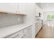 Modern kitchen with white cabinets, stainless steel appliances, and stylish backsplash, ready for cooking at 110 Hickory Grove Dr, Sanford, NC 27330