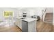 Open-concept kitchen island with stainless steel dishwasher offering easy access to the living and dining areas at 110 Hickory Grove Dr, Sanford, NC 27330