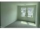 Bedroom featuring plush carpeting and a dual window with a view of neighboring homes at 1116 Merlot Hills Ln, Durham, NC 27704
