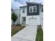 Charming townhome featuring a one-car garage, modern design, and freshly landscaped front yard at 1116 Merlot Hills Ln, Durham, NC 27704