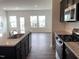 Open-concept kitchen featuring stainless steel appliances, granite countertops, and views of the living room at 1116 Merlot Hills Ln, Durham, NC 27704