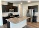 Modern kitchen with stainless steel appliances, granite countertops, and dark cabinetry at 1116 Merlot Hills Ln, Durham, NC 27704