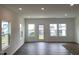 Bright living room featuring hardwood floors, ample windows, and a modern, open-concept design at 1116 Merlot Hills Ln, Durham, NC 27704