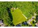 Expansive, bright, lush lawn surrounded by beautiful mature trees providing privacy and space at 114 Bonaparte Dr, Hillsborough, NC 27278