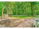 Large backyard with mature trees and white picket fence at 114 Bonaparte Dr, Hillsborough, NC 27278