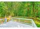 The backyard is enclosed by a white picket fence and has mature trees at 114 Bonaparte Dr, Hillsborough, NC 27278