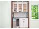 Stylish bar area includes a wine fridge, custom cabinets, and modern backsplash at 114 Bonaparte Dr, Hillsborough, NC 27278