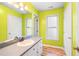 Bathroom featuring lime green walls, a vanity and a mirror at 114 Bonaparte Dr, Hillsborough, NC 27278