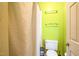 A lime green bathroom featuring a toilet, towel rack, and shower at 114 Bonaparte Dr, Hillsborough, NC 27278