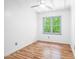 Bright bedroom features natural light, hardwood floors, and a ceiling fan at 114 Bonaparte Dr, Hillsborough, NC 27278