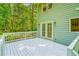 Expansive deck with white railings and french doors is ideal for relaxation and entertaining at 114 Bonaparte Dr, Hillsborough, NC 27278