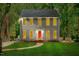 Inviting two-story home with a well-manicured lawn and a striking red front door at 114 Bonaparte Dr, Hillsborough, NC 27278