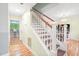Bright foyer with hardwood floors, a staircase with white banisters, and natural light at 114 Bonaparte Dr, Hillsborough, NC 27278