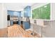 Bright kitchen with blue cabinets, stainless steel appliances, and breakfast bar seating at 114 Bonaparte Dr, Hillsborough, NC 27278