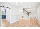 Open-concept living room featuring hardwood floors and a staircase leading to the upper level at 114 Bonaparte Dr, Hillsborough, NC 27278