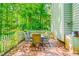 Enjoy outdoor dining on the brick patio with a table, chairs, and privacy fence at 114 Bonaparte Dr, Hillsborough, NC 27278