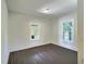 Bedroom featuring hardwood floors and two windows for natural light at 114 N Guthrie Ave, Durham, NC 27703
