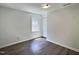 A bright bedroom featuring hardwood flooring and a double-door closet at 114 N Guthrie Ave, Durham, NC 27703