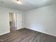A well-lit bedroom with dark hardwood flooring and neutral walls at 114 N Guthrie Ave, Durham, NC 27703